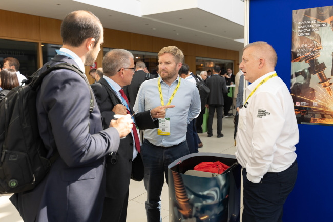 Group of people talking at an exhibition stand